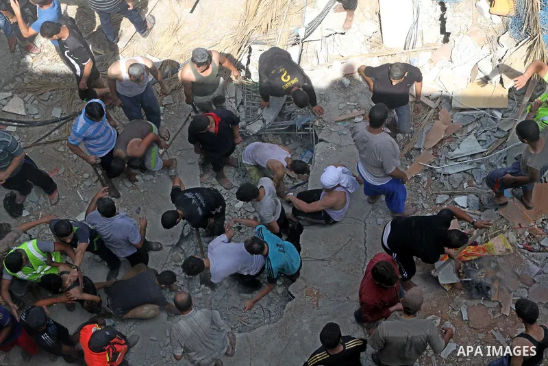 Palestinians dig through the rubble of a building searching for bodies after what police said was an Israeli air strike at Shati (Beach) refugee camp in Gaza City August 4, 2014. A seven-hour truce under which Israel wou...