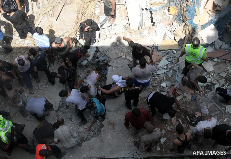 Palestinians dig through the rubble of a building searching for bodies after what police said was an Israeli air strike at Shati (Beach) refugee camp in Gaza City August 4, 2014. A seven-hour truce under which Israel wou...