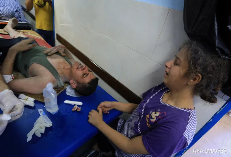 A Palestinian girl cries as her father, wounded in an Israeli air strike on the al-Shati refugee camp, is treated at the al-Shefa hospital in Gaza City, on August 4, 2014. An eight-year-old girl was killed and 30 people...