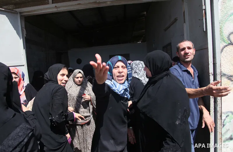 Relatives of nine Palestinians from the Abu Nejim family, whom medics said were killed by an Israeli air strike, mourn during their funeral in Jabaliya refugee camp in the northern Gaza Strip August 4, 2014. A seven-hour...