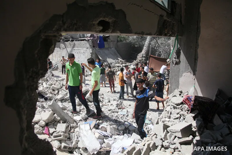Palestinians search for the remains of bodies under the rubble of the Abu Nejim family house which witnesses said was destroyed by an Israeli air strike that killed nine members from the family, in Jabaliya refugee camp...