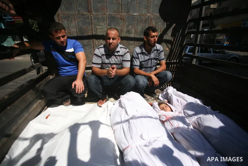 Palestinians look at the bodies of members of the Abu Nejim family, whom medics said were killed by an Israeli air strike, during their funeral in Jabaliya refugee camp in the northern Gaza Strip August 4, 2014. A seven-...