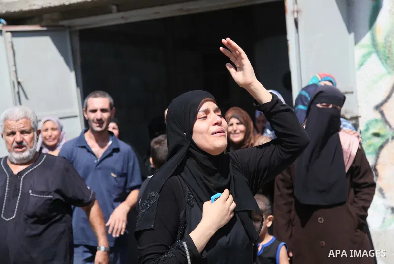 Relatives of nine Palestinians from the Abu Nejim family, whom medics said were killed by an Israeli air strike, mourn during their funeral in Jabaliya refugee camp in the northern Gaza Strip August 4, 2014. A seven-hour...