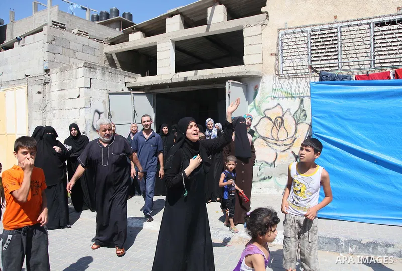 Relatives of nine Palestinians from the Abu Nejim family, whom medics said were killed by an Israeli air strike, mourn during their funeral in Jabaliya refugee camp in the northern Gaza Strip August 4, 2014. A seven-hour...