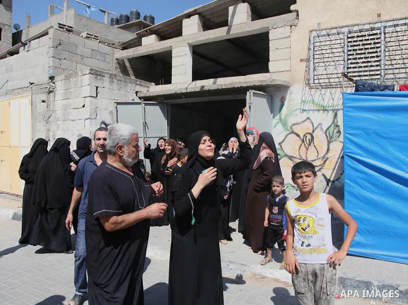 Relatives of nine Palestinians from the Abu Nejim family, whom medics said were killed by an Israeli air strike, mourn during their funeral in Jabaliya refugee camp in the northern Gaza Strip August 4, 2014. A seven-hour...