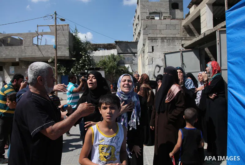 Relatives of nine Palestinians from the Abu Nejim family, whom medics said were killed by an Israeli air strike, mourn during their funeral in Jabaliya refugee camp in the northern Gaza Strip August 4, 2014. A seven-hour...