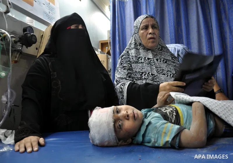 A Palestinian boy, wounded in an Israeli air strike on the al-Shati refugee camp, lies on a stretcher as he is treated at the al-Shefa hospital in Gaza City, on August 4, 2014. An eight-year-old girl was killed and 30 pe...