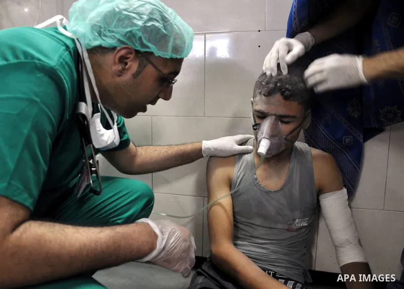 A Palestinian boy, wounded in an Israeli air strike on the al-Shati refugee camp, lies on a floor as he is treated at the al-Shefa hospital in Gaza City, on August 4, 2014. An eight-year-old girl was killed and 30 people...