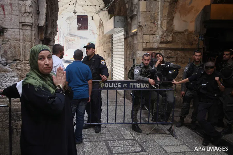 Israeli policemen prevent Palestinian worshippers from entering the Al-Aqsa mosque compound in the Old City of Jerusalem on August 4, 2014. Photo by Saeed Qaq