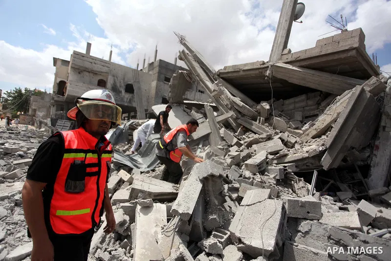 Palestinian rescue workers search for victims of the Israeli military offensive, close to the Rafah refugee camp, in southern Gaza Strip, on August 4, 2014. Civil defence workers and medics are searching the neighborhood...