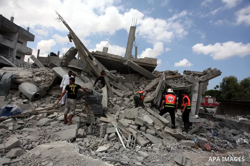 Palestinian rescue workers search for victims of the Israeli military offensive, close to the Rafah refugee camp, in southern Gaza Strip, on August 4, 2014. Civil defence workers and medics are searching the neighborhood...