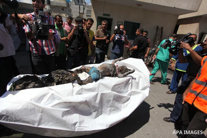 Palestinians carry the dead body of a woman after removing it from under the rubble of a house which witnesses said was destroyed in an Israeli air strike, in Rafah in the southern Gaza Strip August 4, 2014. Palestinians...