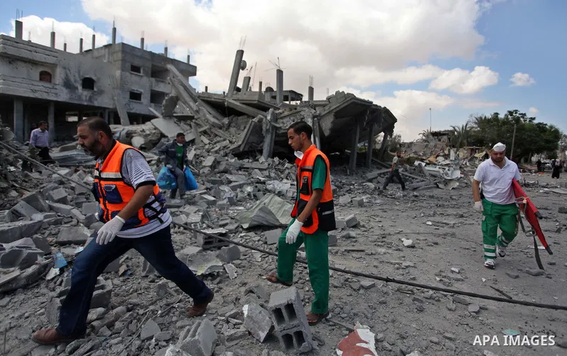 Palestinian rescue workers search for victims of the Israeli military offensive, close to the Rafah refugee camp, in southern Gaza Strip, on August 4, 2014. Civil defence workers and medics are searching the neighborhood...