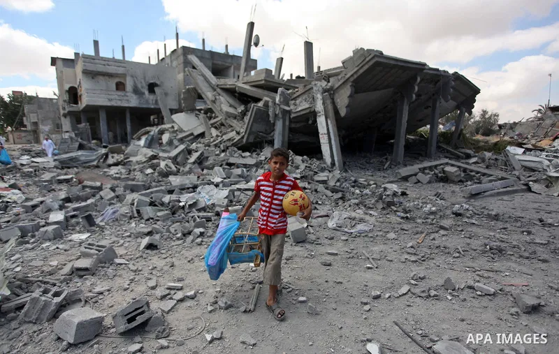 Palestinians walk upon the debris of a house which witnesses said was destroyed in an Israeli air strike, in Rafah in the southern Gaza Strip August 4, 2014. Palestinians accused Israel of breaking its own ce asefire on...