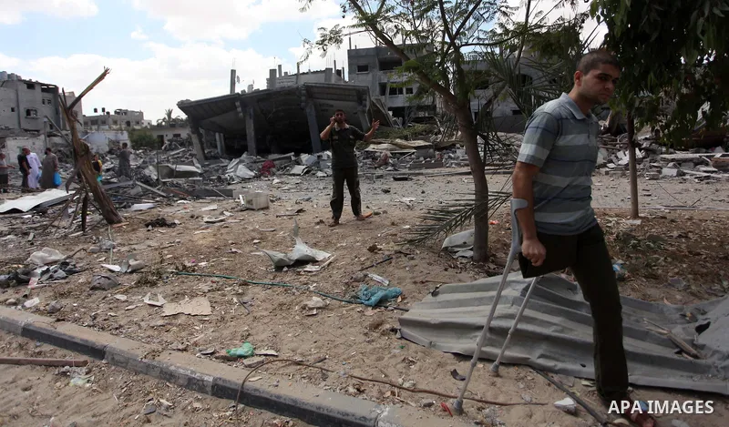 Palestinians walk upon the debris of a house which witnesses said was destroyed in an Israeli air strike, in Rafah in the southern Gaza Strip August 4, 2014. Palestinians accused Israel of breaking its own ce asefire on...