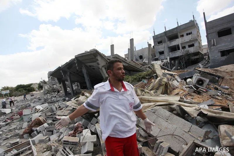 Palestinian rescue worker searches for victims of the Israeli military offensive, close to the Rafah refugee camp, in southern Gaza Strip, on August 4, 2014. Civil defence workers and medics are searching the neighborhoo...