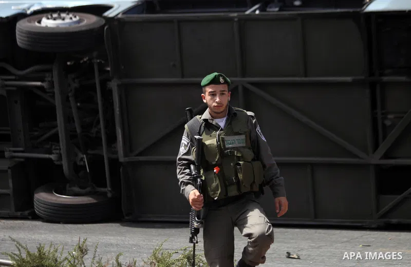 Israeli forensic police inspect the scene of attack in Jerusalem, Israel, 04 August 2014. Israeli police have shot dead the driver of a bulldozer in Jerusalem after he rammed the vehicle into a passenger bus. A civilian...