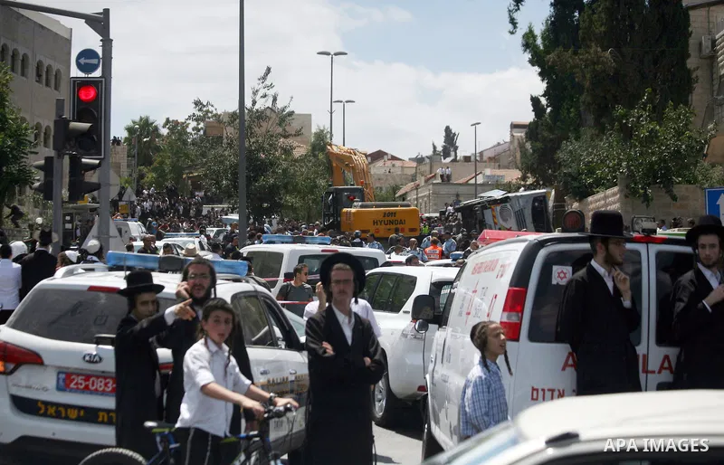 Israeli ultra orthodox Jews watch as Israeli police work at the scene after a Palestinian man rammed an excavator into a bus, on August 4, 2014 in Jerusalem, killing one person and lightly injuring five others. The incid...