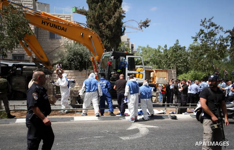 Israeli rescue workers stand near a body at the scene of an attack in Jerusalem, Monday, Aug. 4, 2014. An Israeli-declared cease-fire and troop withdrawals slowed violence in the Gaza war Monday, though an attack on Isra...