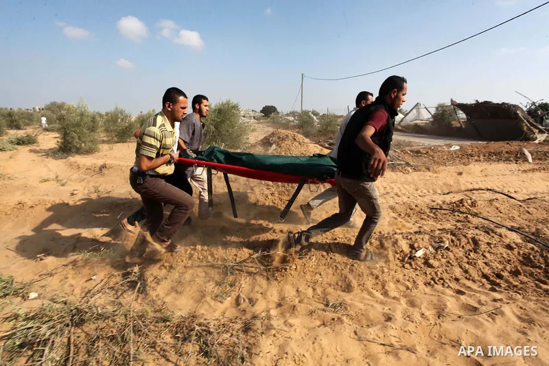Medics carry the dead body of a Palestinian man after removing it from under the rubble of a house which witnesses said was destroyed during the Israeli offensive, in the east of Rafah in the southern Gaza Strip August 5...