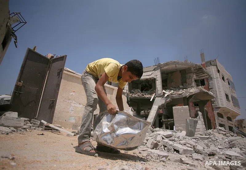 Palestinians search through rubble of their destroyed houses hit by Israeli strikes in Khuzaa, east of Khan Younis, in the northern Gaza Strip, Tuesday, Aug. 5, 2014. Israel and Hamas began observing a temporary cease-fi...