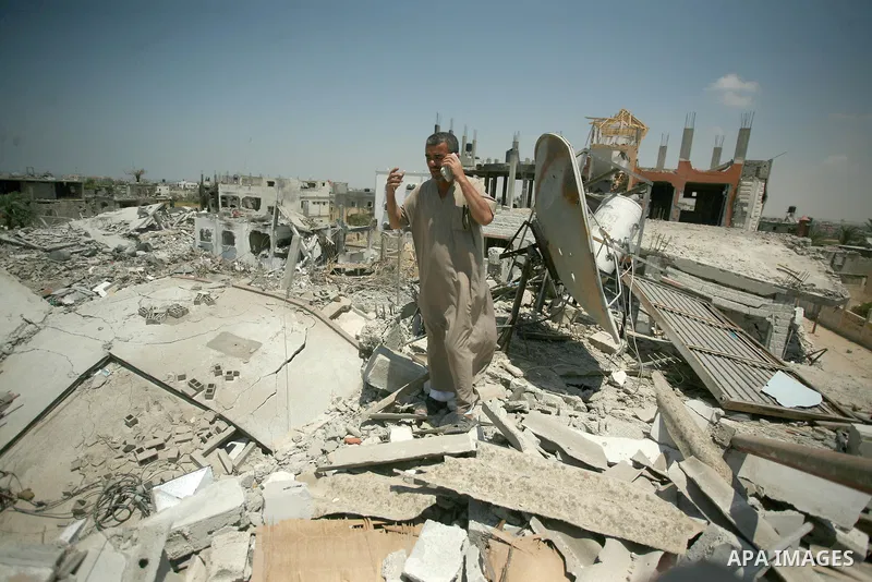 Palestinians search through rubble of their destroyed houses hit by Israeli strikes in Khuzaa, east of Khan Younis, in the northern Gaza Strip, Tuesday, Aug. 5, 2014. Israel and Hamas began observing a temporary cease-fi...