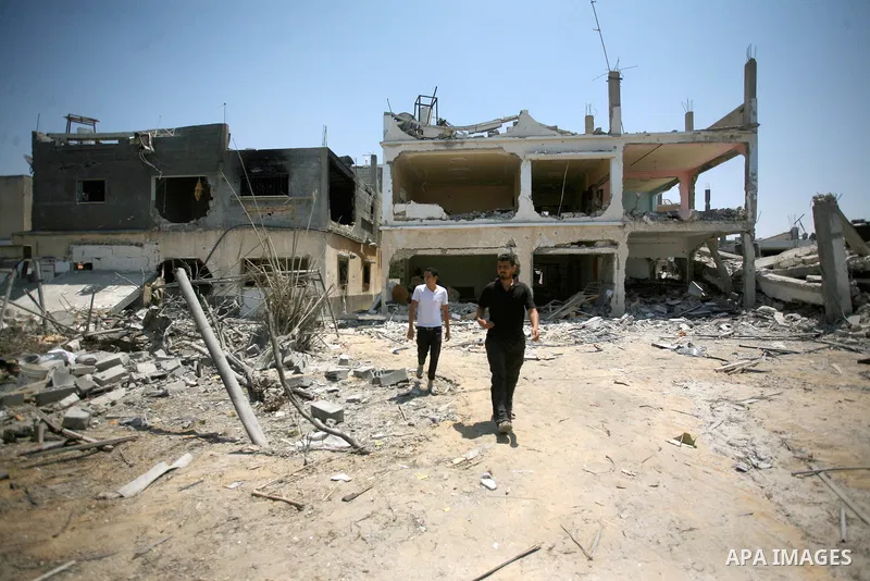 Palestinians search through rubble of their destroyed houses hit by Israeli strikes in Khuzaa, east of Khan Younis, in the northern Gaza Strip, Tuesday, Aug. 5, 2014. Israel and Hamas began observing a temporary cease-fi...