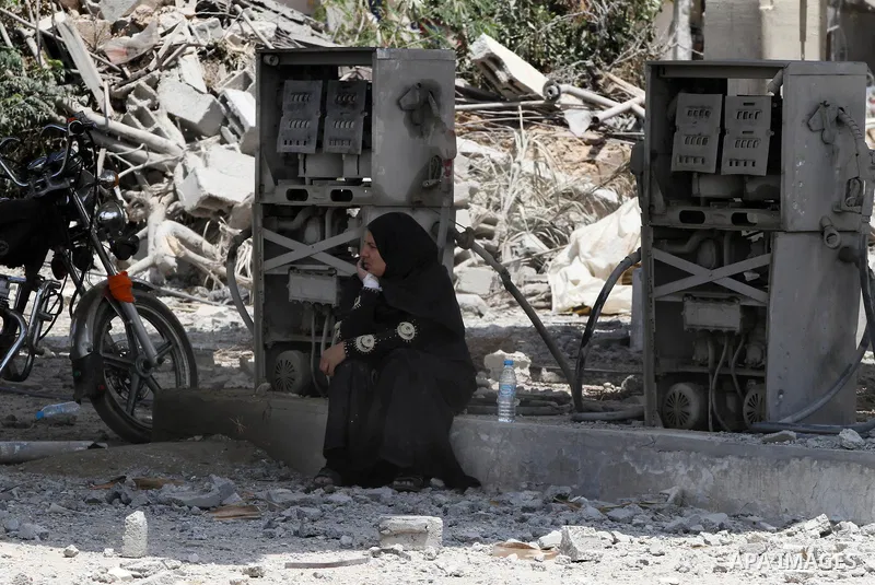 Palestinians search through rubble of their destroyed houses hit by Israeli strikes in Khuzaa, east of Khan Younis, in the northern Gaza Strip, Tuesday, Aug. 5, 2014. Israel and Hamas began observing a temporary cease-fi...