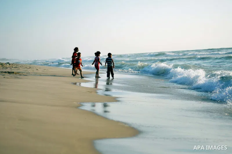 Palestinian children play at the beach on Gaza city, on August 5, 2014. Israel and Hamas began observing a temporary cease-fire on Tuesday that sets the stage for talks in Egypt on a broader deal on the Gaza Strip, inclu...