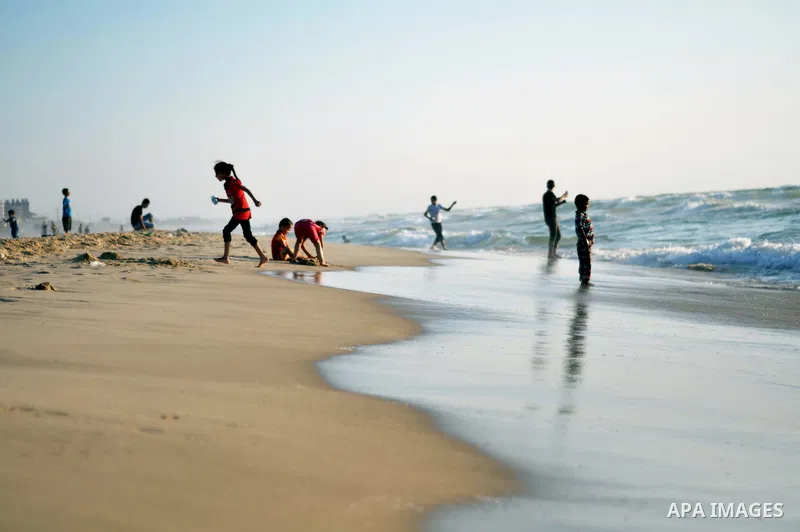 Palestinian children play at the beach on Gaza city, on August 5, 2014. Israel and Hamas began observing a temporary cease-fire on Tuesday that sets the stage for talks in Egypt on a broader deal on the Gaza Strip, inclu...