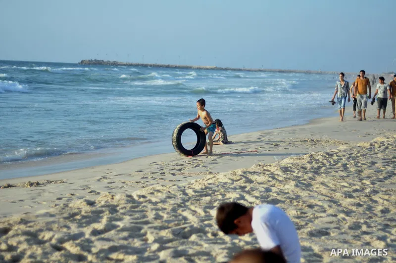 Palestinian children play at the beach on Gaza city, on August 5, 2014. Israel and Hamas began observing a temporary cease-fire on Tuesday that sets the stage for talks in Egypt on a broader deal on the Gaza Strip, inclu...