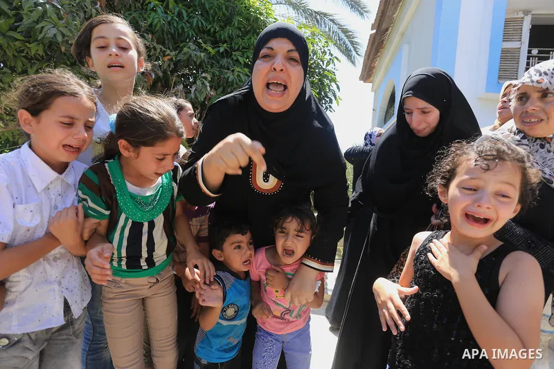 Palestinian relatives mourn the body of Palestinian of Al-Quds brigades, the military wing of Islamic Jihad, Shaban Al-Dahdouh, during his funeral in Gaza City, 06 August 2014. For the first time in nearly a month, the g...
