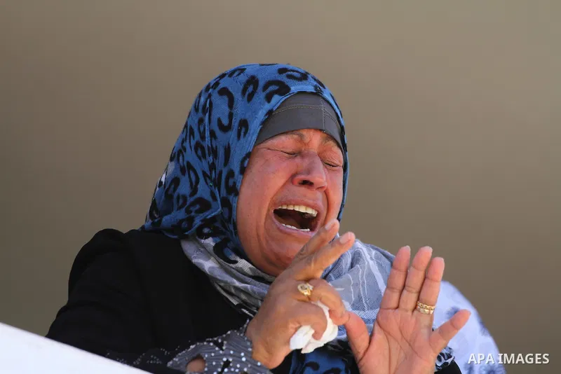 Palestinian relatives mourn the body of Palestinian of Al-Quds brigades, the military wing of Islamic Jihad, Shaban Al-Dahdouh, during his funeral in Gaza City, 06 August 2014. For the first time in nearly a month, the g...