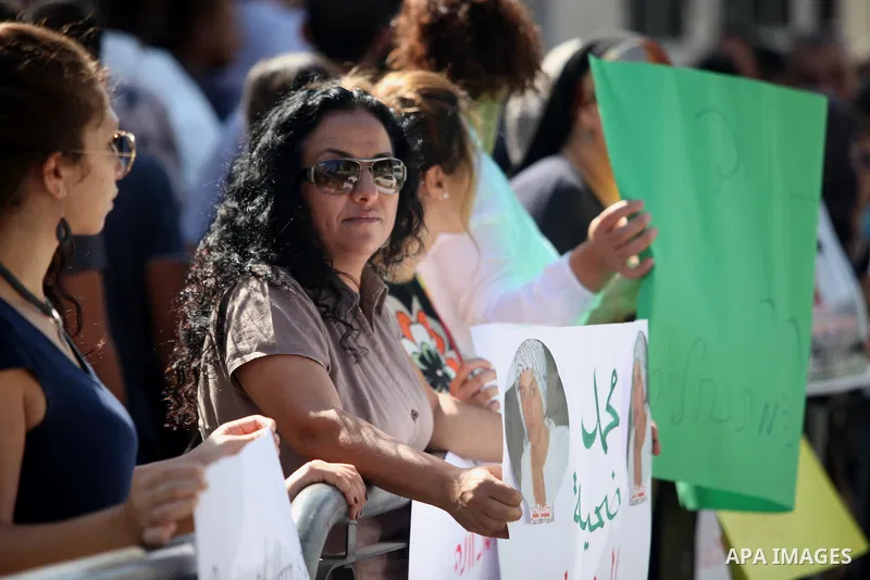 Palestinians hold signs and posters depicting Palestinian teen Mohammed Abu Khudair during a protest outside Jerusalem District Court August 6, 2014. Jerusalem District Court on Wednesday remanded Yosef Ben David, one of...