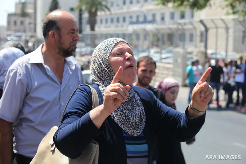 Grandmother's of Mohammed Abu Khudair, cries during a protest outside Jerusalem District Court August 6, 2014. Jerusalem District Court on Wednesday remanded Yosef Ben David, one of three Israeli suspects in the murder o...