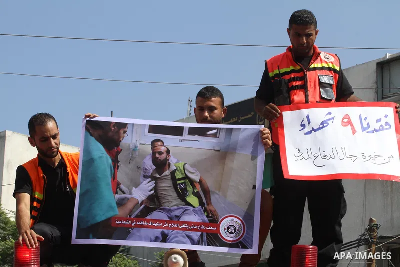 Palestinian members of civil defense take part a protest against the Israeli aggression on them during the war on Gaza Strip, in Gaza city on August 7, 2014. The ceasefire, which came into effect on August 5, has brought...