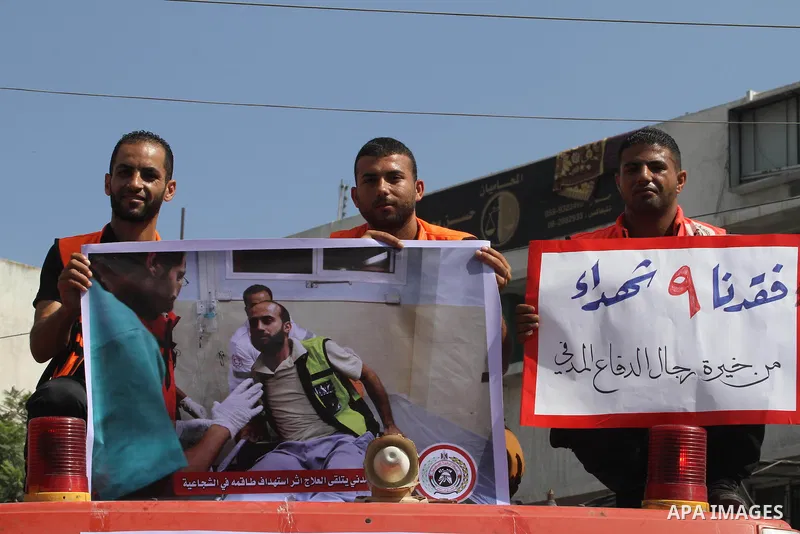 Palestinian members of civil defense take part a protest against the Israeli aggression on them during the war on Gaza Strip, in Gaza city on August 7, 2014. The ceasefire, which came into effect on August 5, has brought...