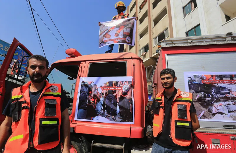 Palestinian members of civil defense take part a protest against the Israeli aggression on them during the war on Gaza Strip, in Gaza city on August 7, 2014. The ceasefire, which came into effect on August 5, has brought...