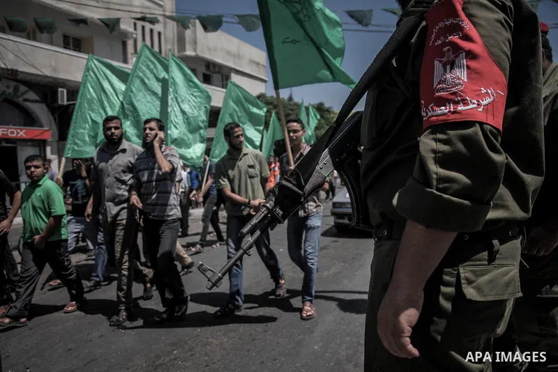 A member of Palestinian security forces stands guard as demonstrators attend a rally in support of the Hamas movement in downtown Gaza City on August 7, 2014 while diplomatic efforts entered a final countdown in Cairo as...