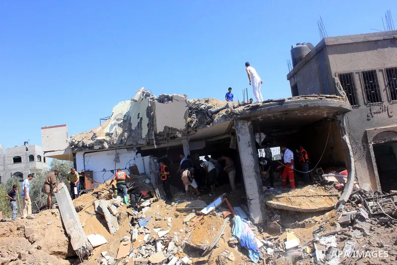 Palestinian rescue workers search in the rubble of a destroyed house following an Israeli air strike in Gaza city on August 08, 2014. Israel launched air strikes across the Gaza Strip on Friday in response to Palestinian...