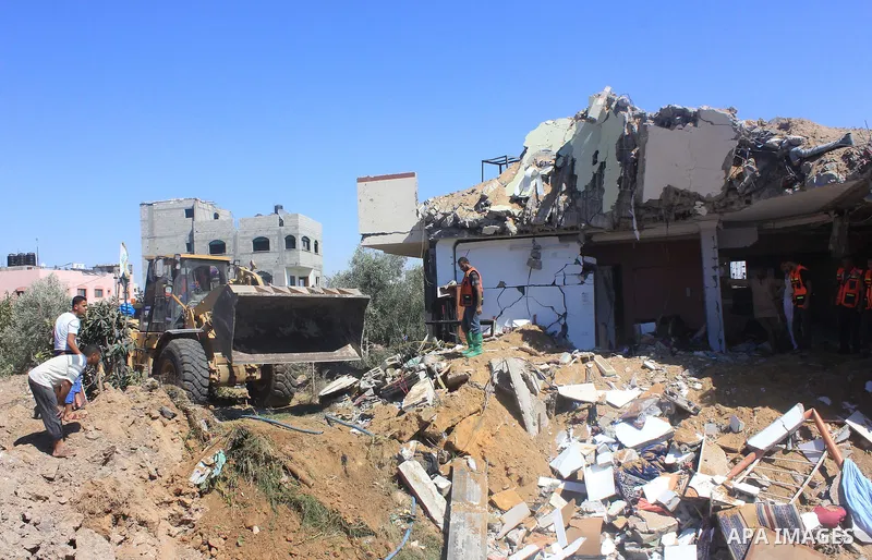 Palestinian rescue workers search in the rubble of a destroyed house following an Israeli air strike in Gaza city on August 08, 2014. Israel launched air strikes across the Gaza Strip on Friday in response to Palestinian...