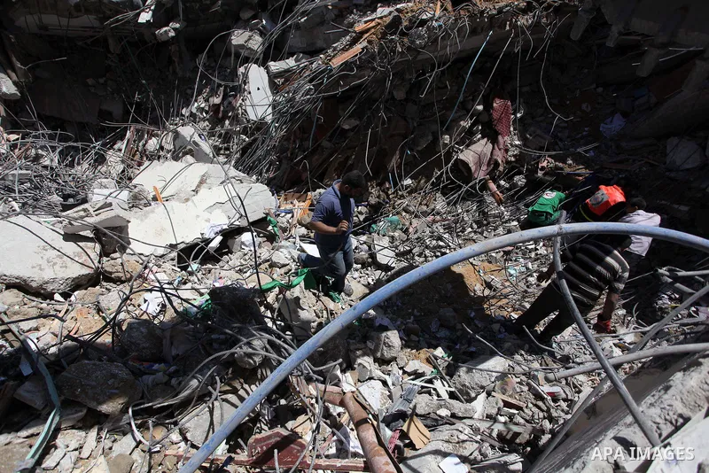 Palestinians search in the rubble of al-Qassam mosque, which witnesses said was hit by an Israeli air strike, in Nuseirat refugee camp in the central Gaza Strip on August 9, 2014. Israel launched more than 20 aerial atta...