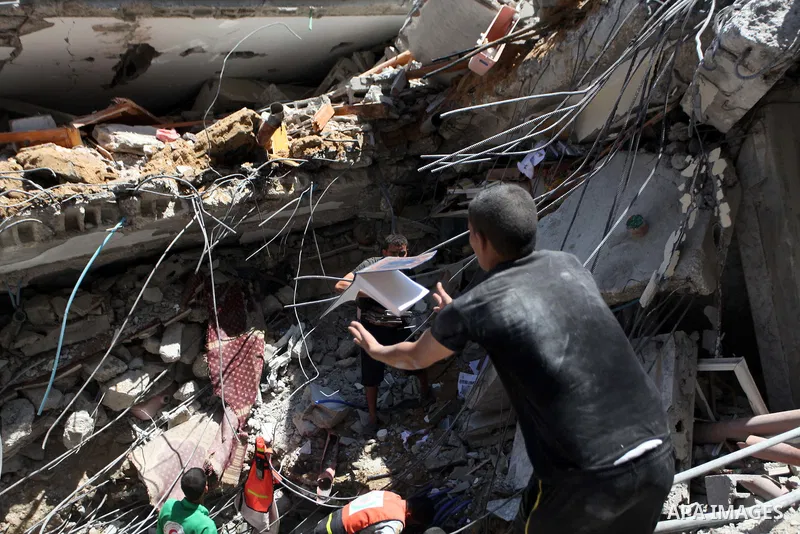 Palestinians search in the rubble of al-Qassam mosque, which witnesses said was hit by an Israeli air strike, in Nuseirat refugee camp in the central Gaza Strip on August 9, 2014. Israel launched more than 20 aerial atta...