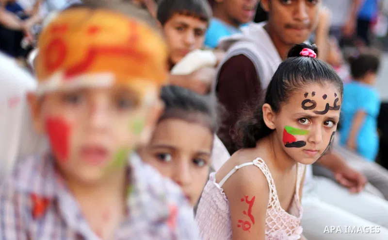 Palestinians celebrate during the wedding ceremony of a displaced couple at a United Nations-run school sheltering displaced Palestinians from the Israeli offensive, in Shati refugee camp in Gaza City August 13, 2014. Th...