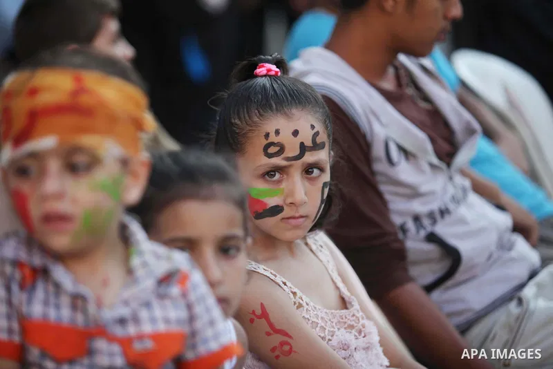 Palestinians celebrate during the wedding ceremony of a displaced couple at a United Nations-run school sheltering displaced Palestinians from the Israeli offensive, in Shati refugee camp in Gaza City August 13, 2014. Th...