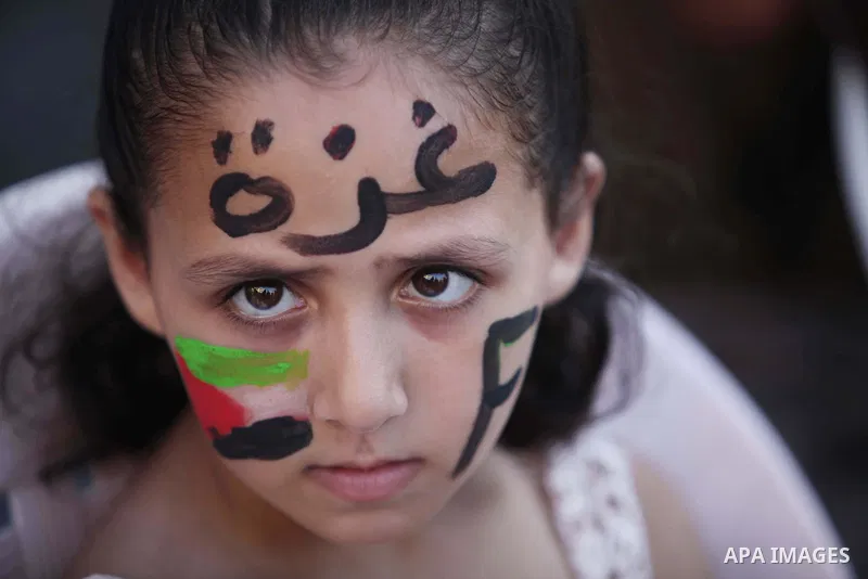 Palestinians celebrate during the wedding ceremony of a displaced couple at a United Nations-run school sheltering displaced Palestinians from the Israeli offensive, in Shati refugee camp in Gaza City August 13, 2014. Th...