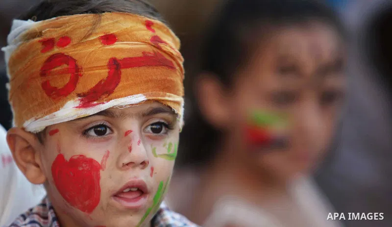 Palestinians celebrate during the wedding ceremony of a displaced couple at a United Nations-run school sheltering displaced Palestinians from the Israeli offensive, in Shati refugee camp in Gaza City August 13, 2014. Th...