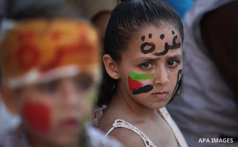 Palestinians celebrate during the wedding ceremony of a displaced couple at a United Nations-run school sheltering displaced Palestinians from the Israeli offensive, in Shati refugee camp in Gaza City August 13, 2014. Th...