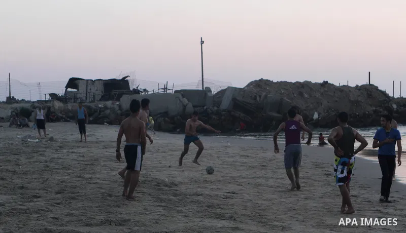 Palestinians take a dip in the sea as the sun sets over the Gaza City, on August 14, 2014.A fresh five-day ceasefire between Palestinian militants and Israel went into force early Thursday, agreed at the end of a three-d...