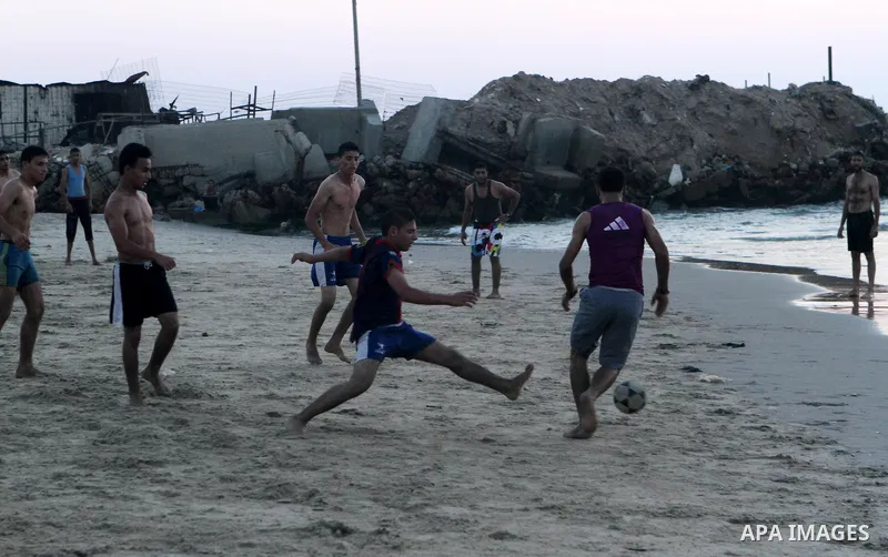 Palestinians take a dip in the sea as the sun sets over the Gaza City, on August 14, 2014.A fresh five-day ceasefire between Palestinian militants and Israel went into force early Thursday, agreed at the end of a three-d...
